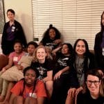 Nursing students sitting with a group of teenagers,