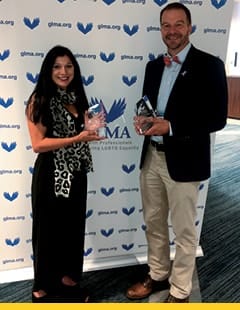 Jessica Landry and Todd Tartavoulle holding their achievement awards.