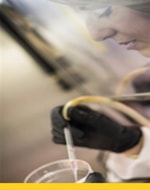 Dr. Marcy Purnell examines a sample in a petri dish.