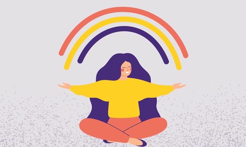 Woman sitting with a rainbow above her