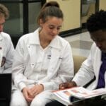 Three students sitting together studying