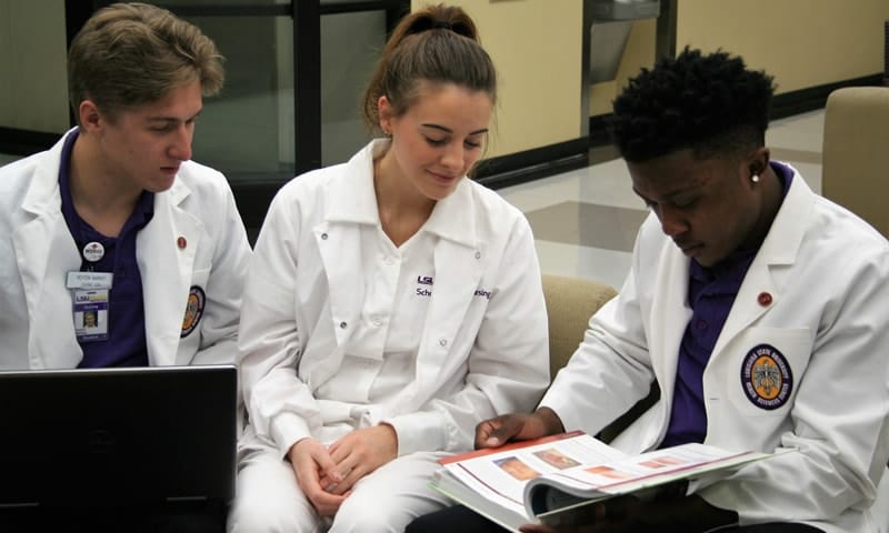 Three students sitting together studying