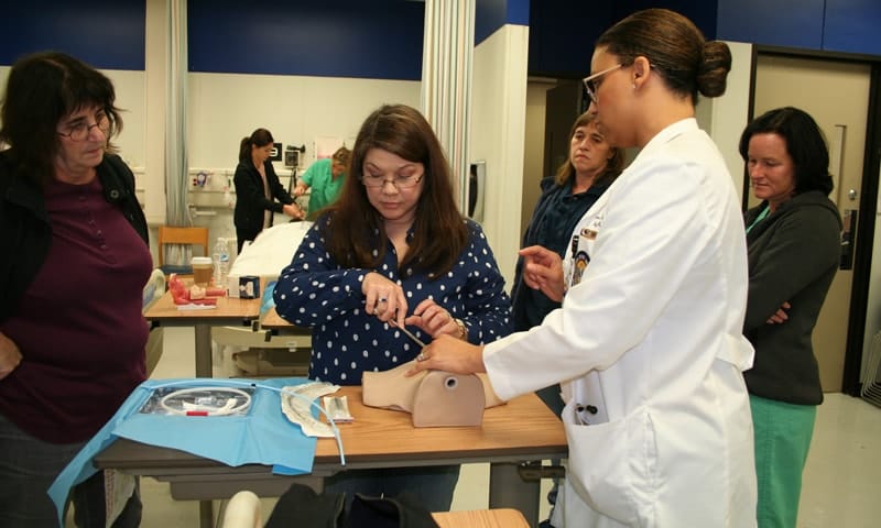 Nursing student and group of people working on a demonstration
