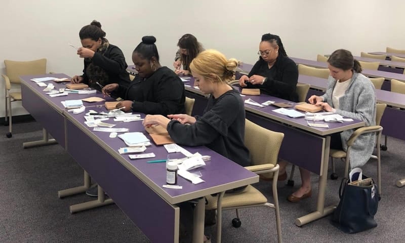 Group of nursing students working at tables