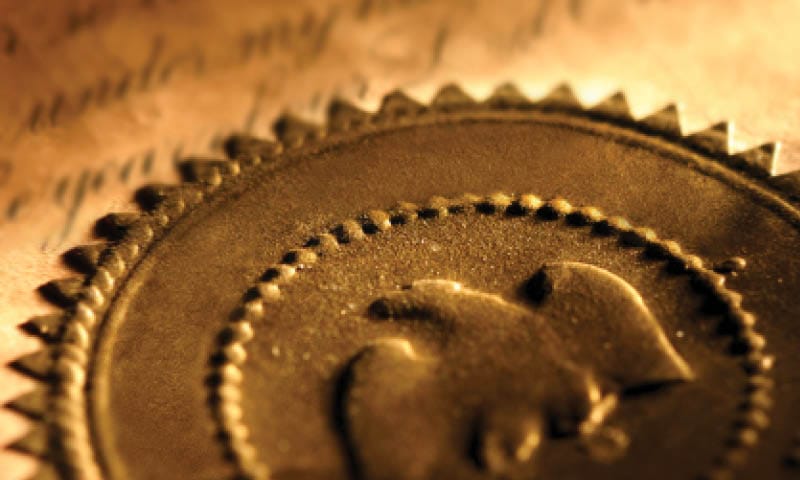 A gold seal with an eagle on it