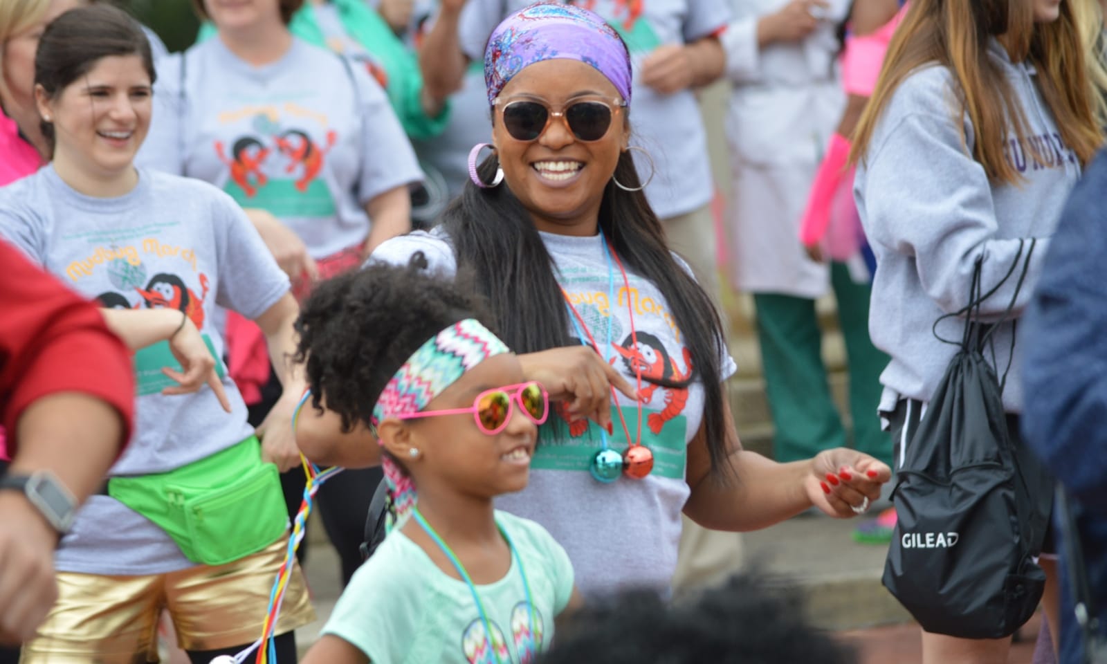 2010s: Women and a young girl smile at an outdoor event
