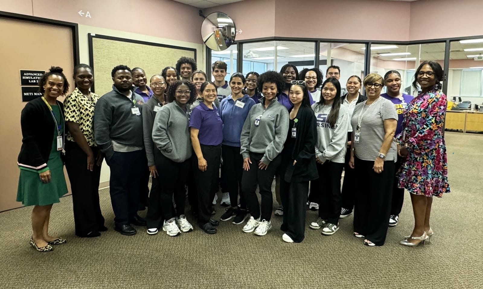 New nursing students work together on an anatomy simulation table.