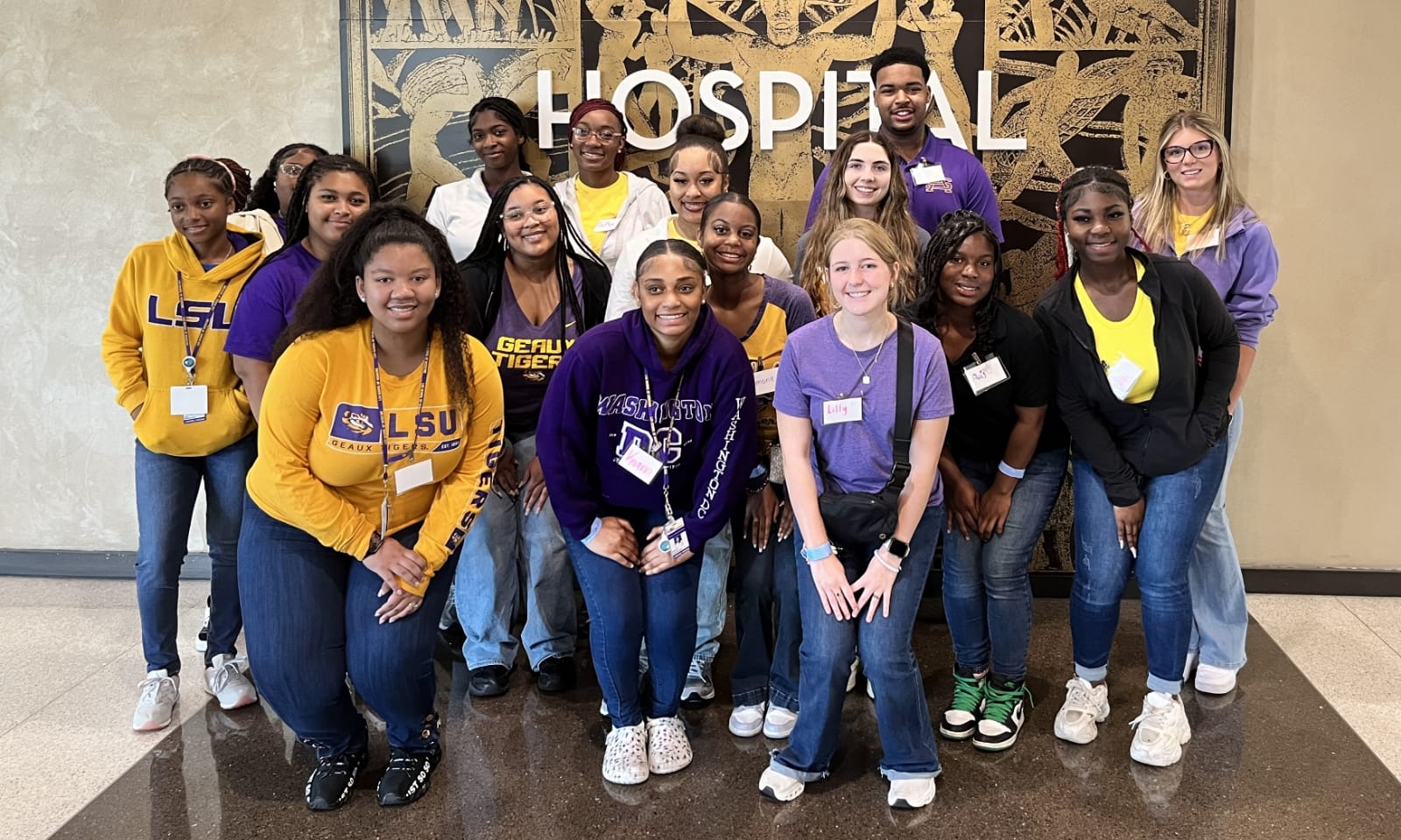 New nursing students work together on an anatomy simulation table.