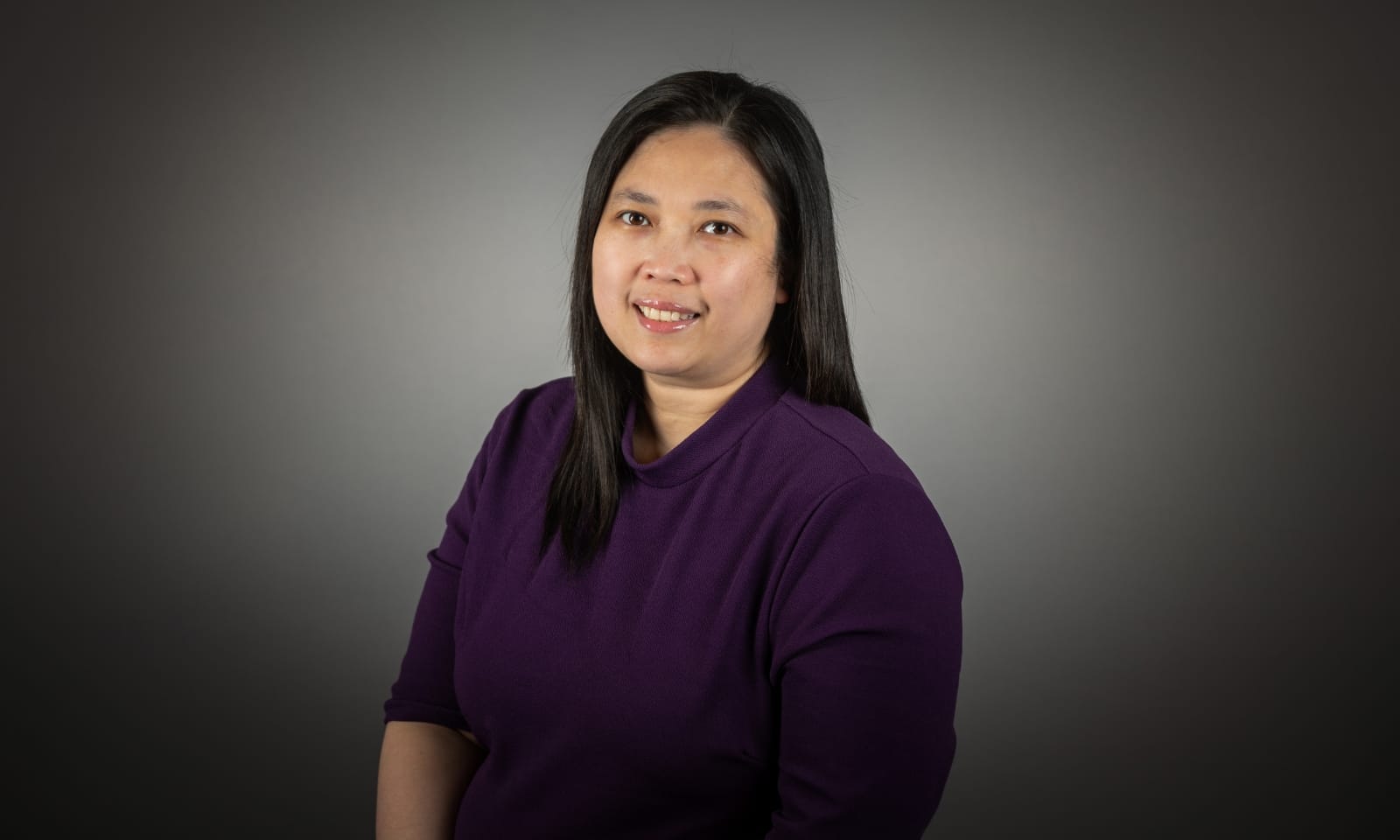 A woman smiles for the camera in a headshot photo.